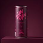 A single can of UNPOP! Sublime Cola stands on a matching dark pedestal against a dark plum background. The can is dark magenta with bright pink lettering that reads 'UNPOP!' and smaller text 'sublime cola' and 'citrus lime'.